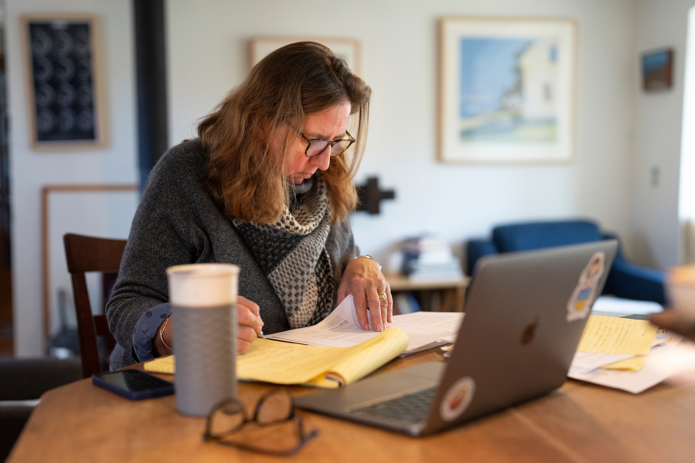 Adult student working on a computer in a kitchen