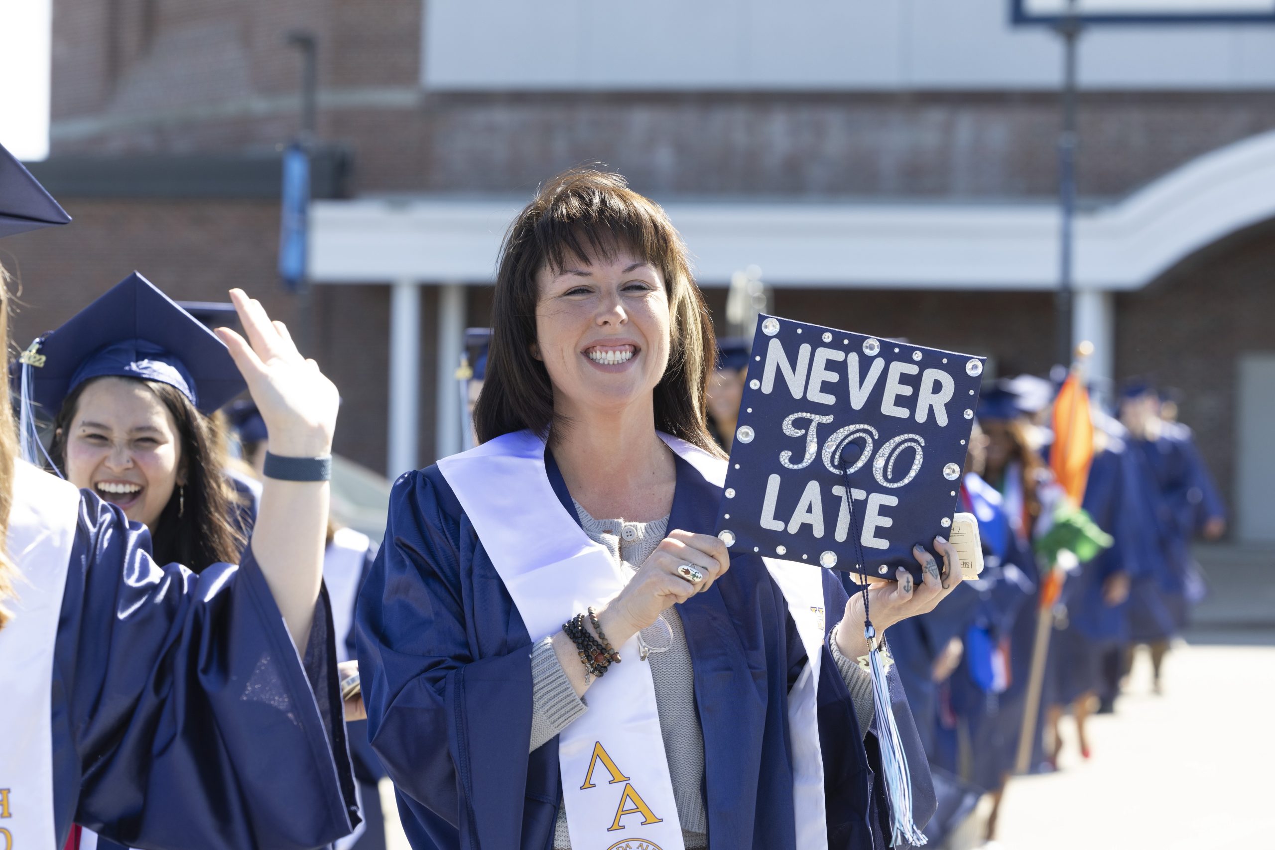 Graduate with cap that says" Never too late"