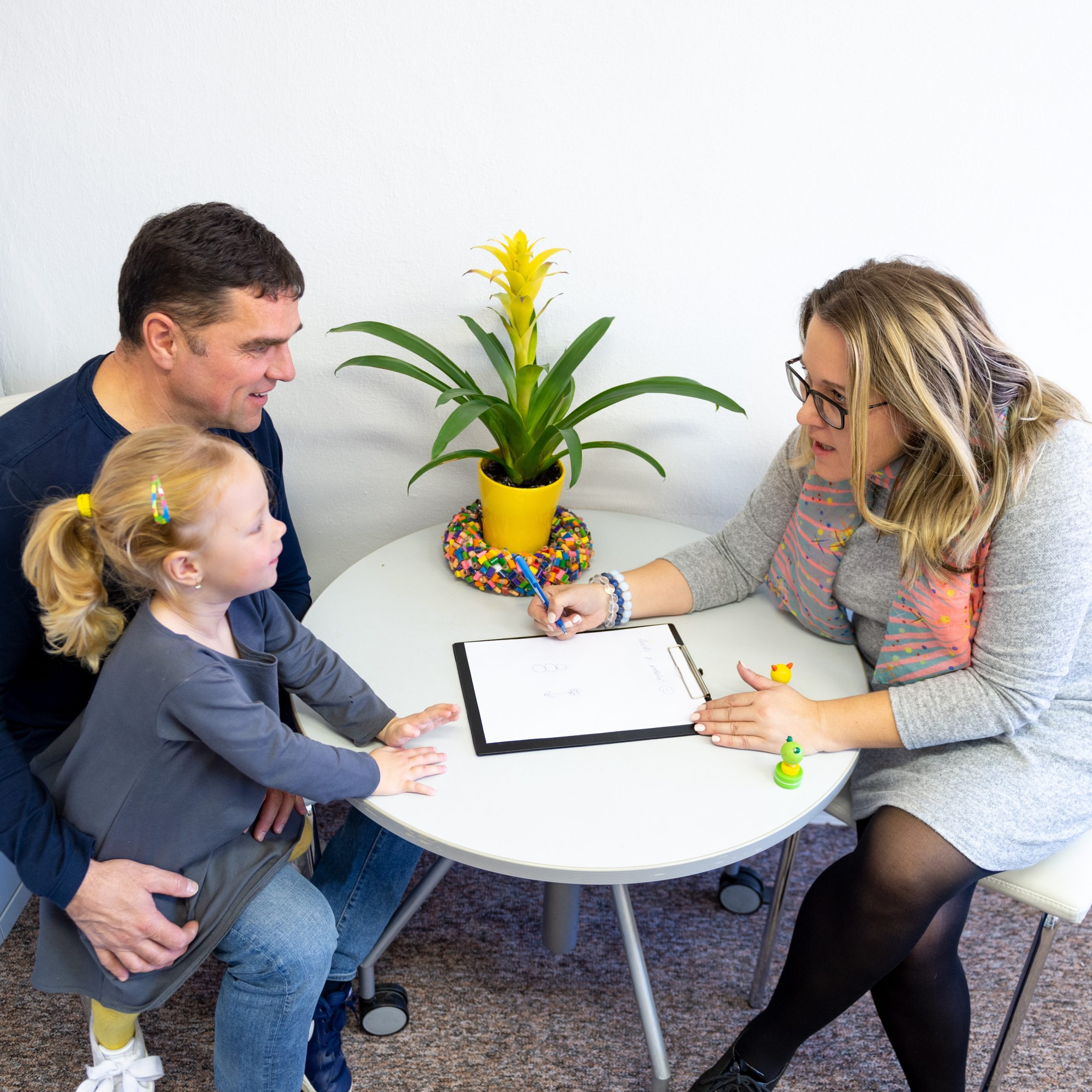 Social worker talking with a parent and child