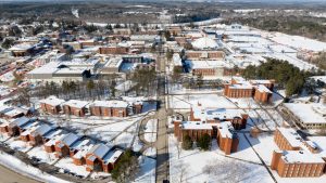 An aerial view of a snowy UMaine campus