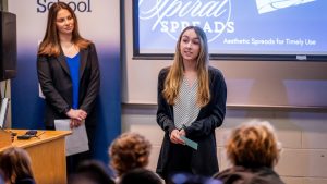 A photo of a person giving a presentation.