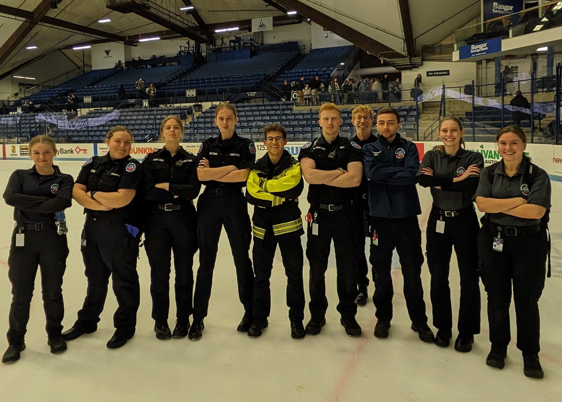 UVAC Members stand in a line for a photo on the Alfond Arena ice rink.
