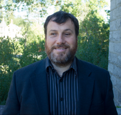 Headshot of Dr. Nicholas Giudice. He is wearing a blue striped shirt and a navy blue blazer.