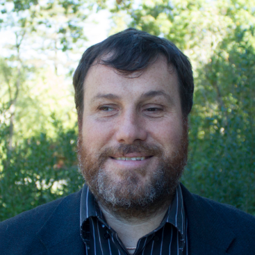 Headshot of Dr. Nicholas Giudice. He is wearing a blue striped shirt and a navy blue blazer.