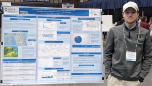 David Libby standing beside his Maine Water Conference poster