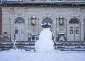 Snowman in front of a building