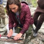 Student measuring a fish