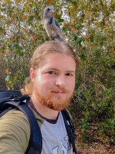 head shot of Percy with a bird on his head. 