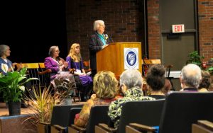 woman giving speech at podium