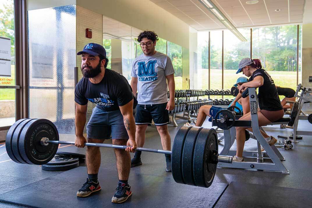 A photo of people using exercise equipment in UMaine's New Balance Recreation Center