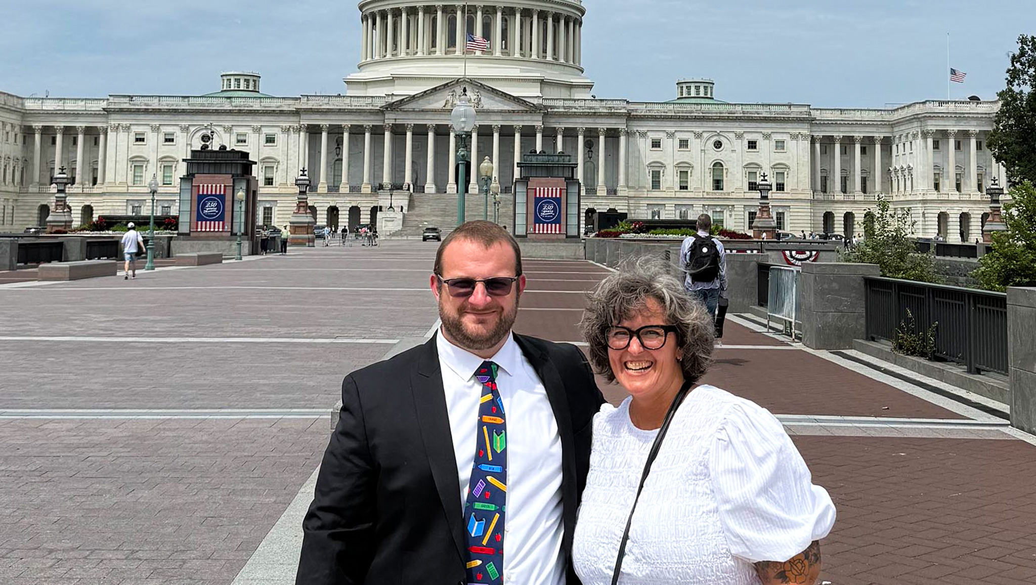 A photo of Sean Cavanaugh with a woman in front of a building