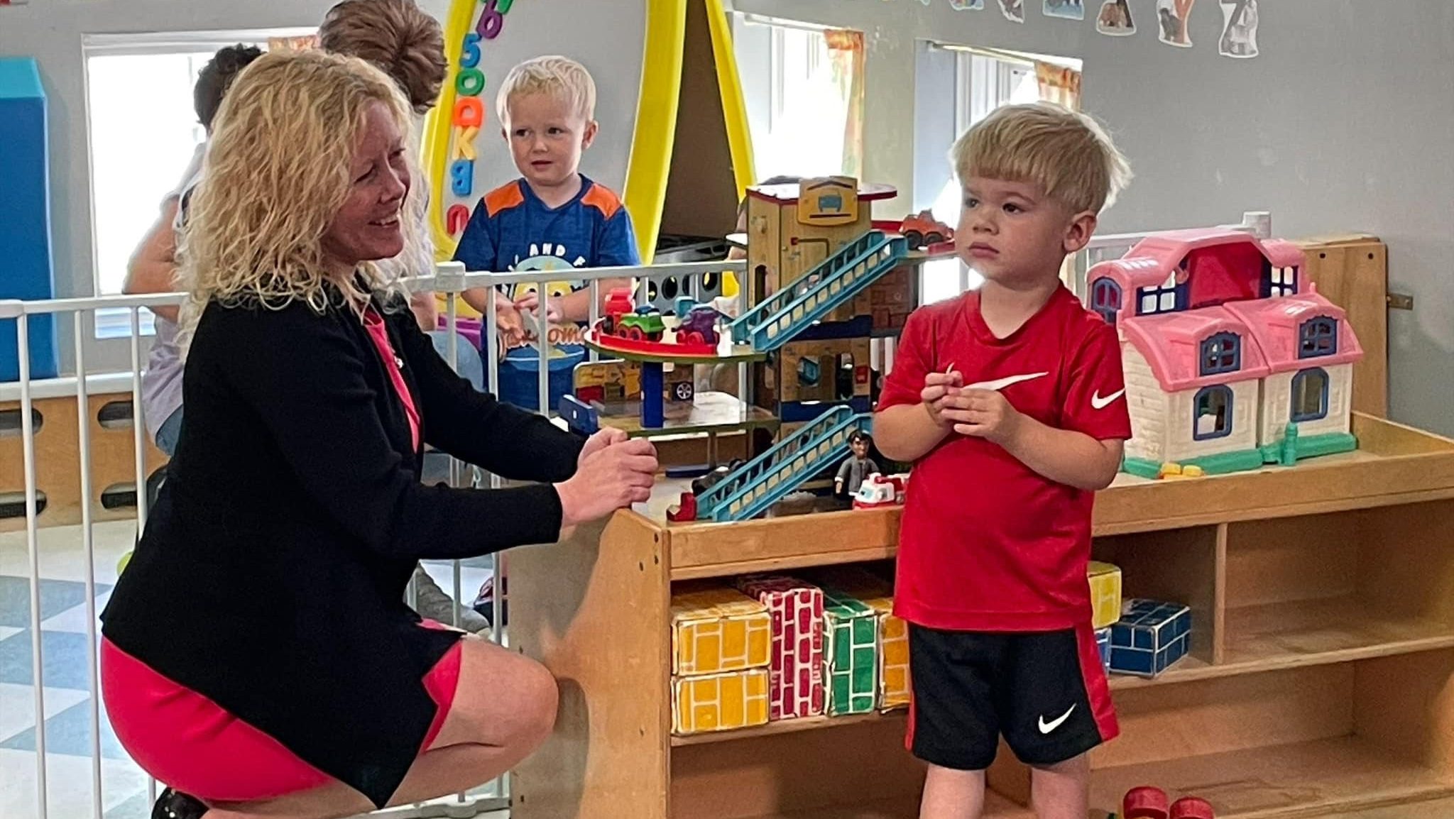 A photo of Kara Hay with a child
