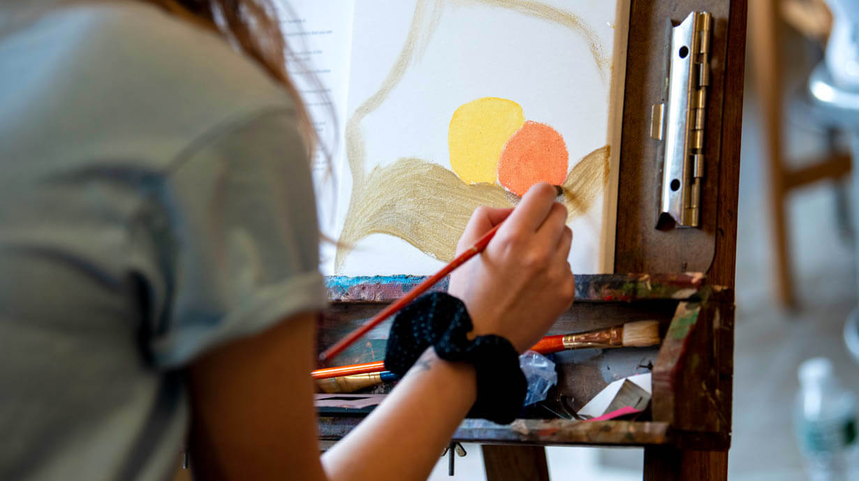 A woman painting on canvas