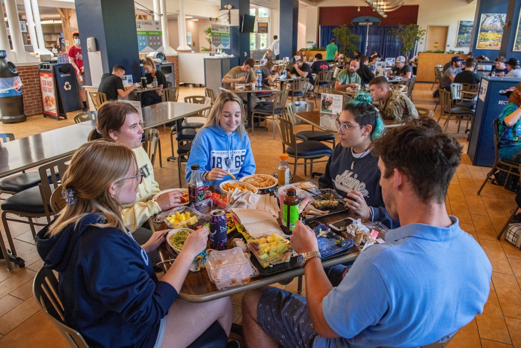 A photo of students sitting around a table eating