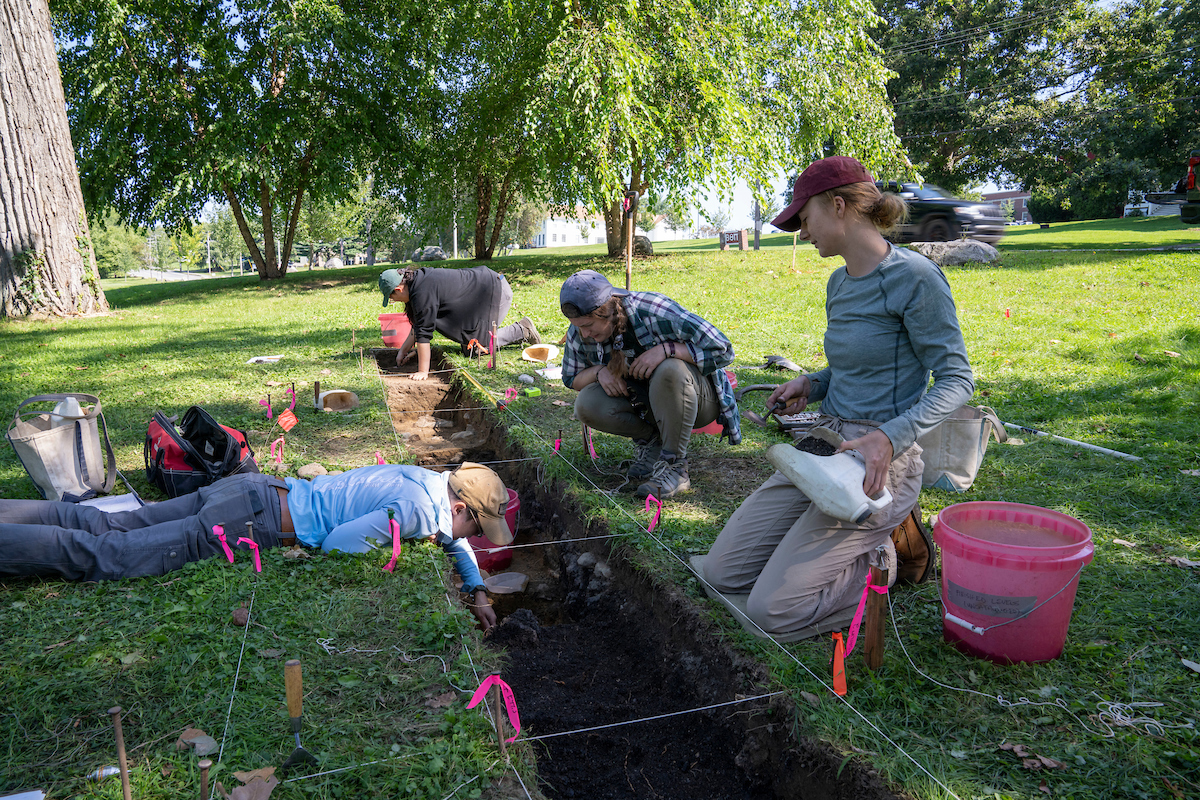 A photo of students working on an archaeological dig on campus