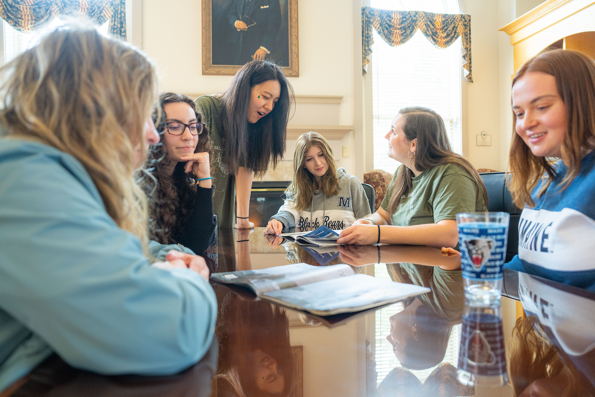 A photo of Honors Students sitting around a table