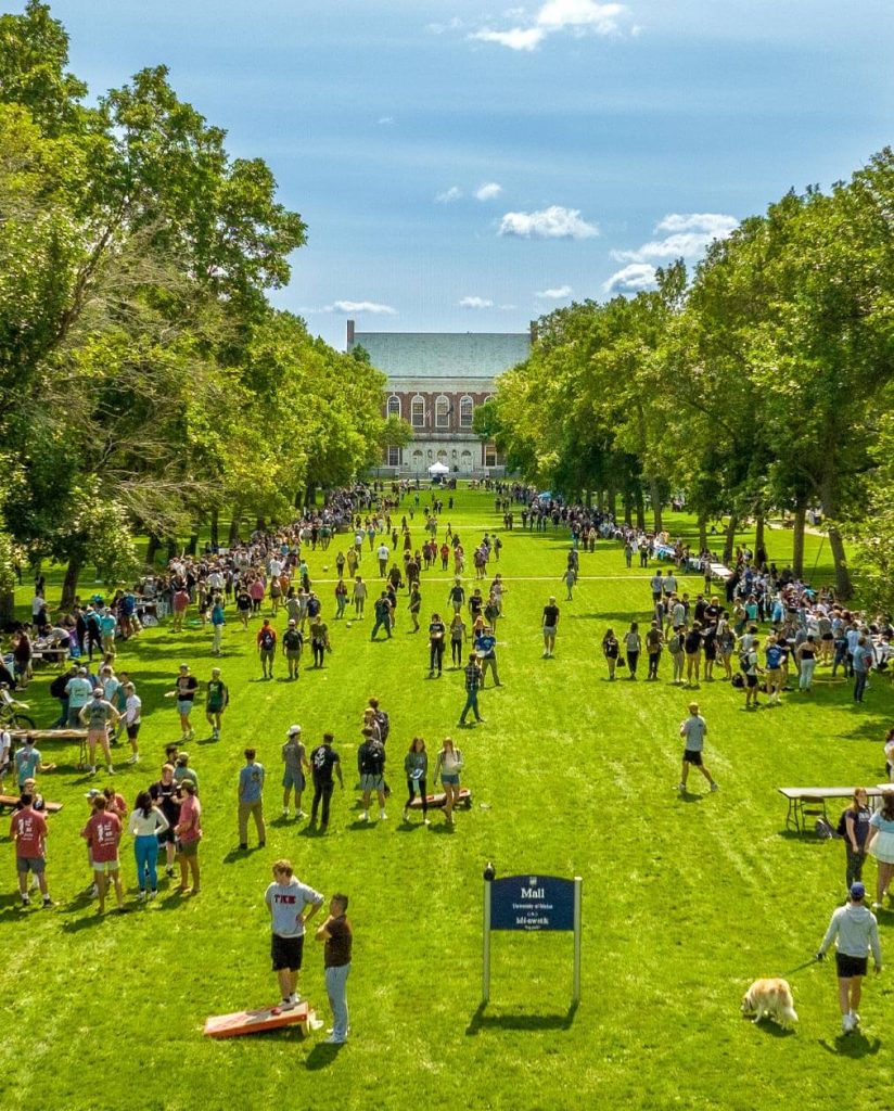 A photo of people on UMaine's Mall in late summer