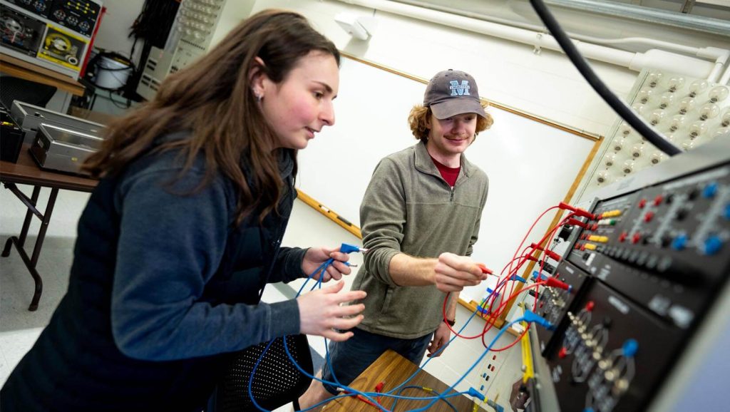 A photo of two students working in an electrical engineering lab