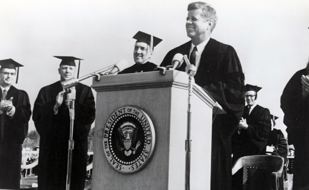 An archival photo of JFK speaking on campus