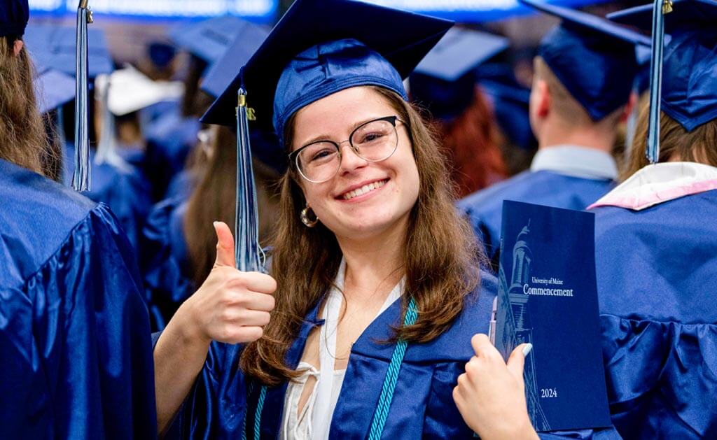 A photo of a UMaine graduate at commencement